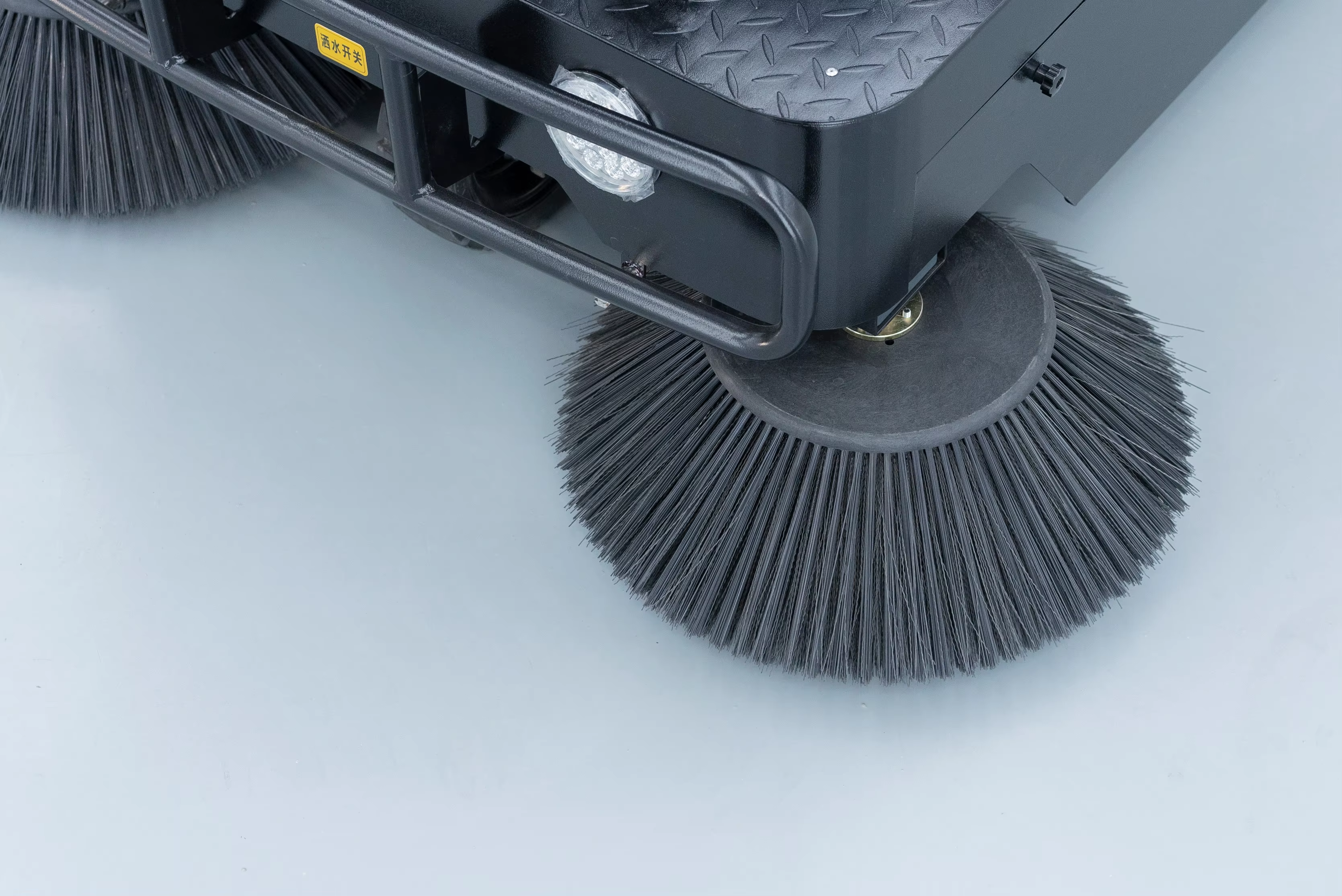 Ride-on sweeper brush detail